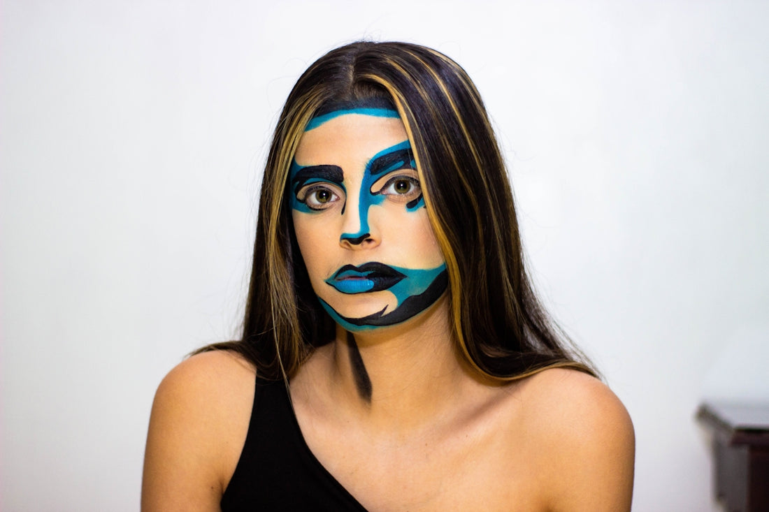 woman in black tank top with blue eye shadow