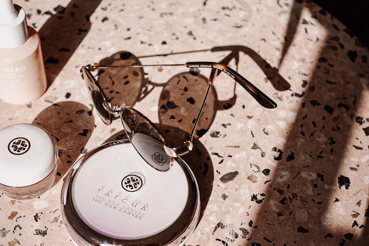 silver framed eyeglasses on white and brown table